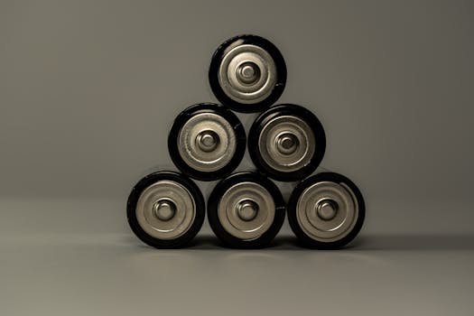 Home Metallic AA batteries stacked in a pyramid shape, symbolizing power and energy storage.