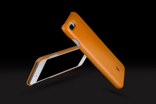 Home Dynamic image of sleek orange phone cases in a minimalist style, emphasizing modern technology and design.